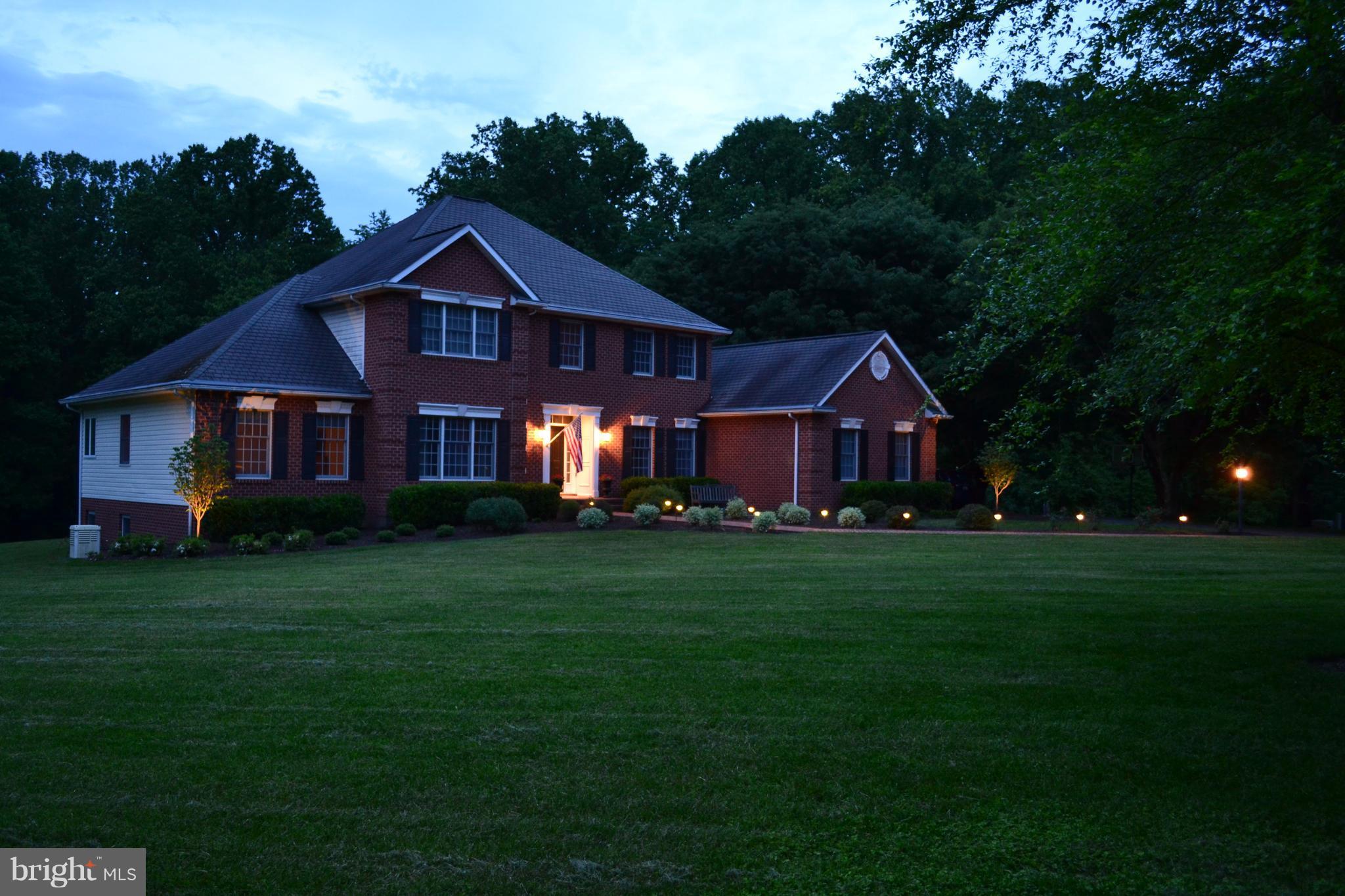 2818 Paper Mill Road Phoenix, MD 21131 - Photo 2 of 30 a front of a house with table and garden