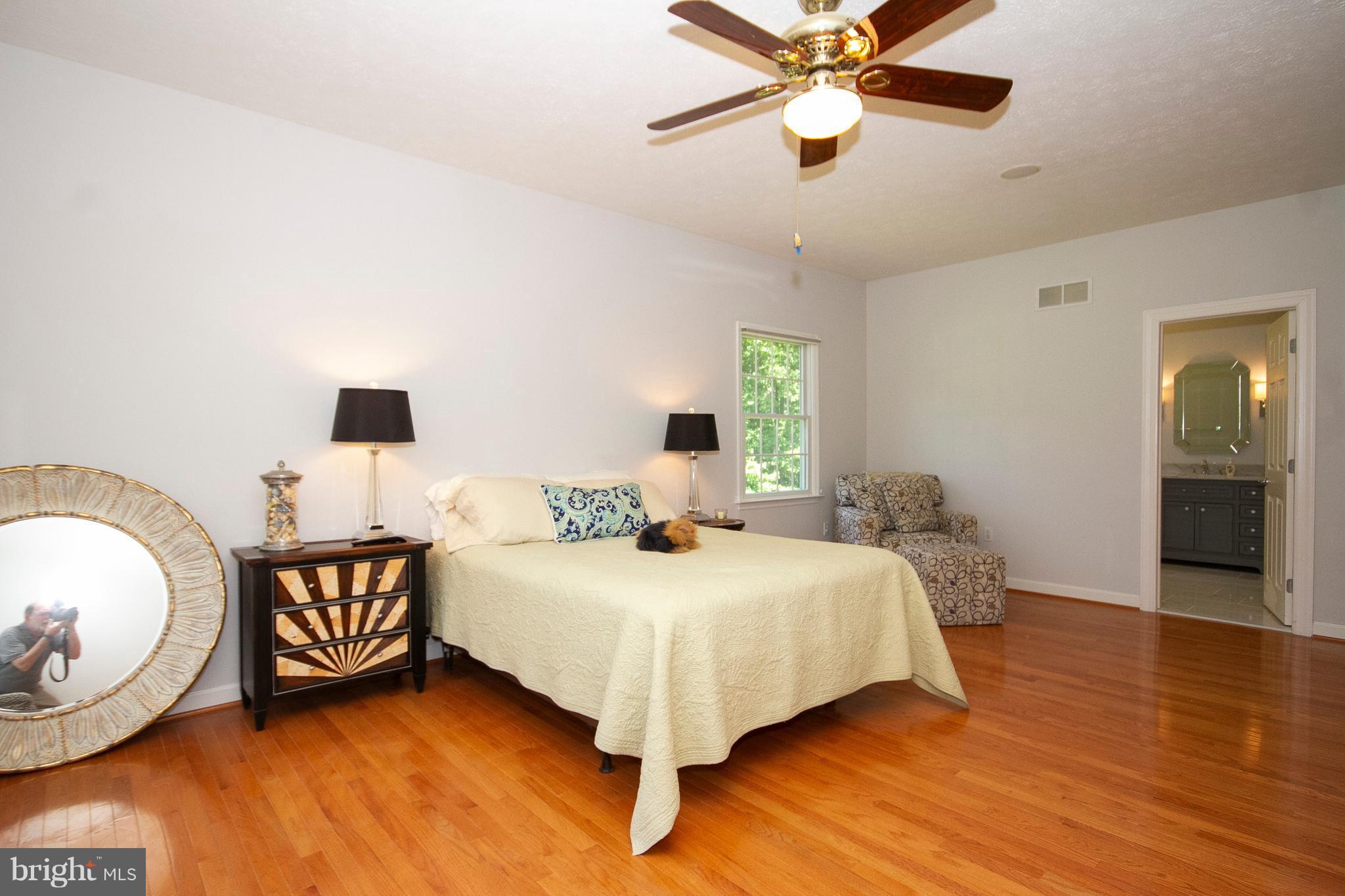 2818 Paper Mill Road Phoenix, MD 21131 - Photo 13 of 30 a bedroom with a bed and a chandelier