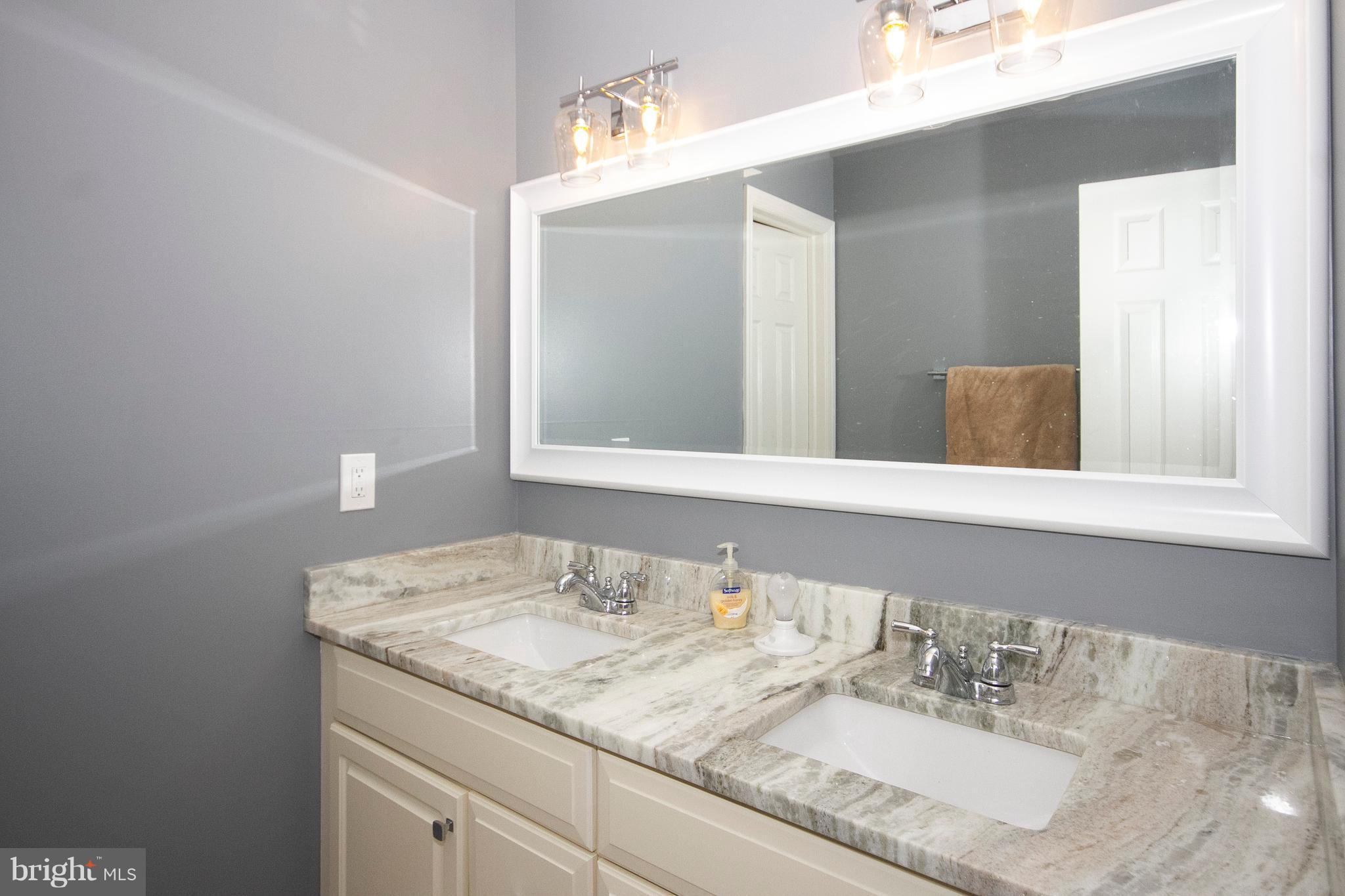 2818 Paper Mill Road Phoenix, MD 21131 - Photo 17 of 30 a bathroom with a granite countertop sink and a mirror