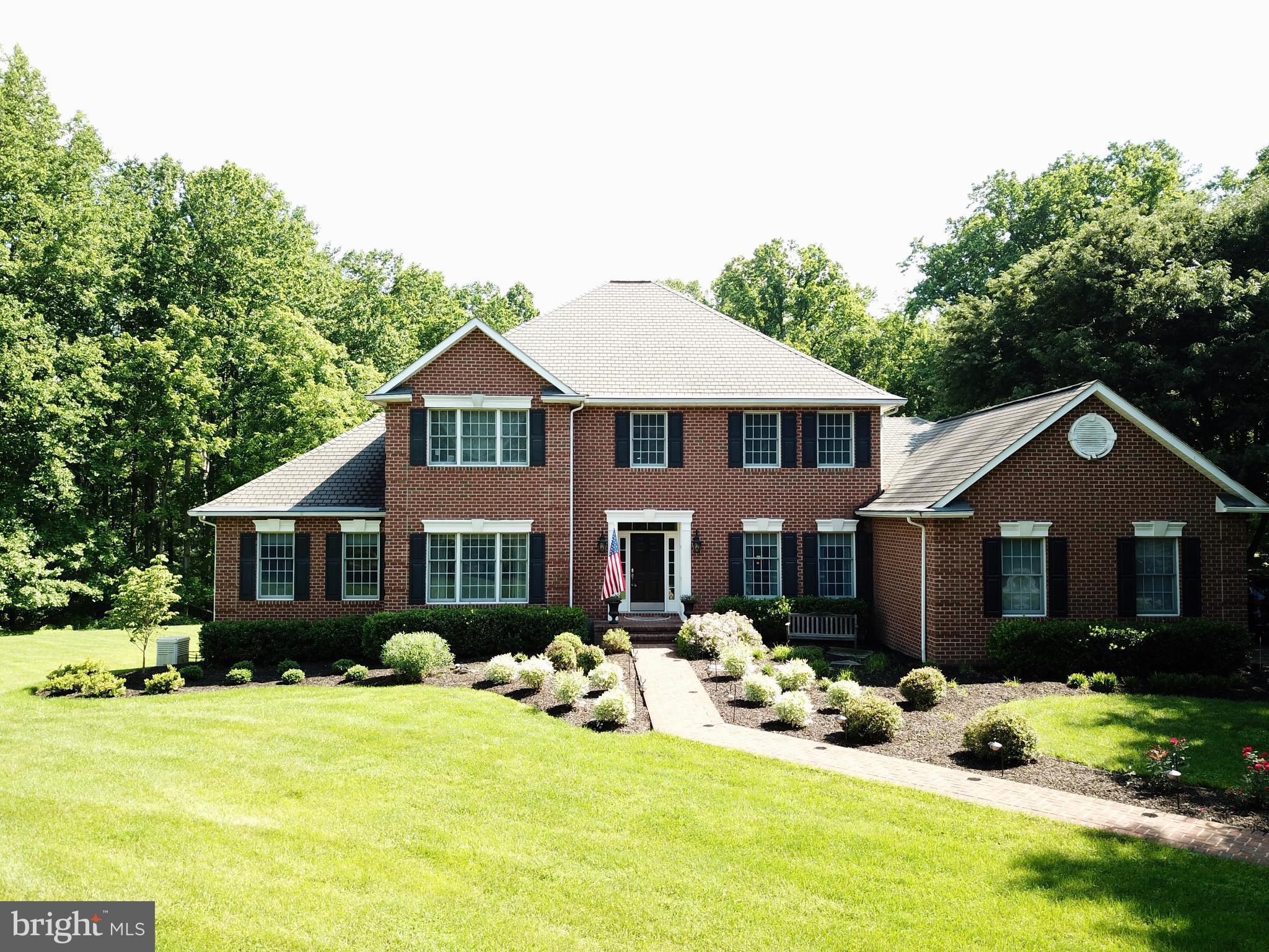 2818 Paper Mill Road Phoenix, MD 21131 - Photo 3 of 30 a front view of a house with a yard outdoor seating and garage