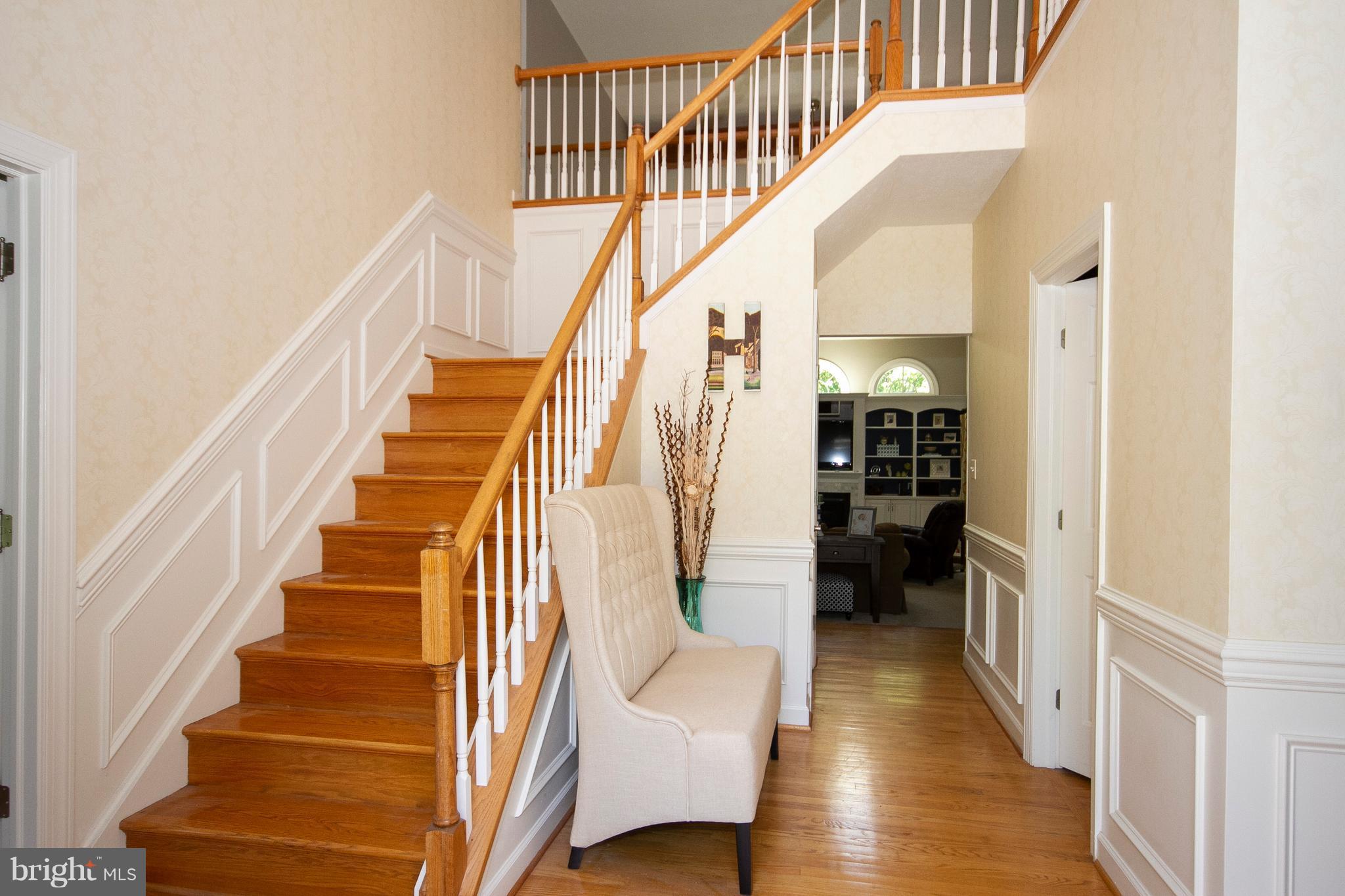 2818 Paper Mill Road Phoenix, MD 21131 - Photo 25 of 30 a view of staircase with lots of frames on wall and wooden floor