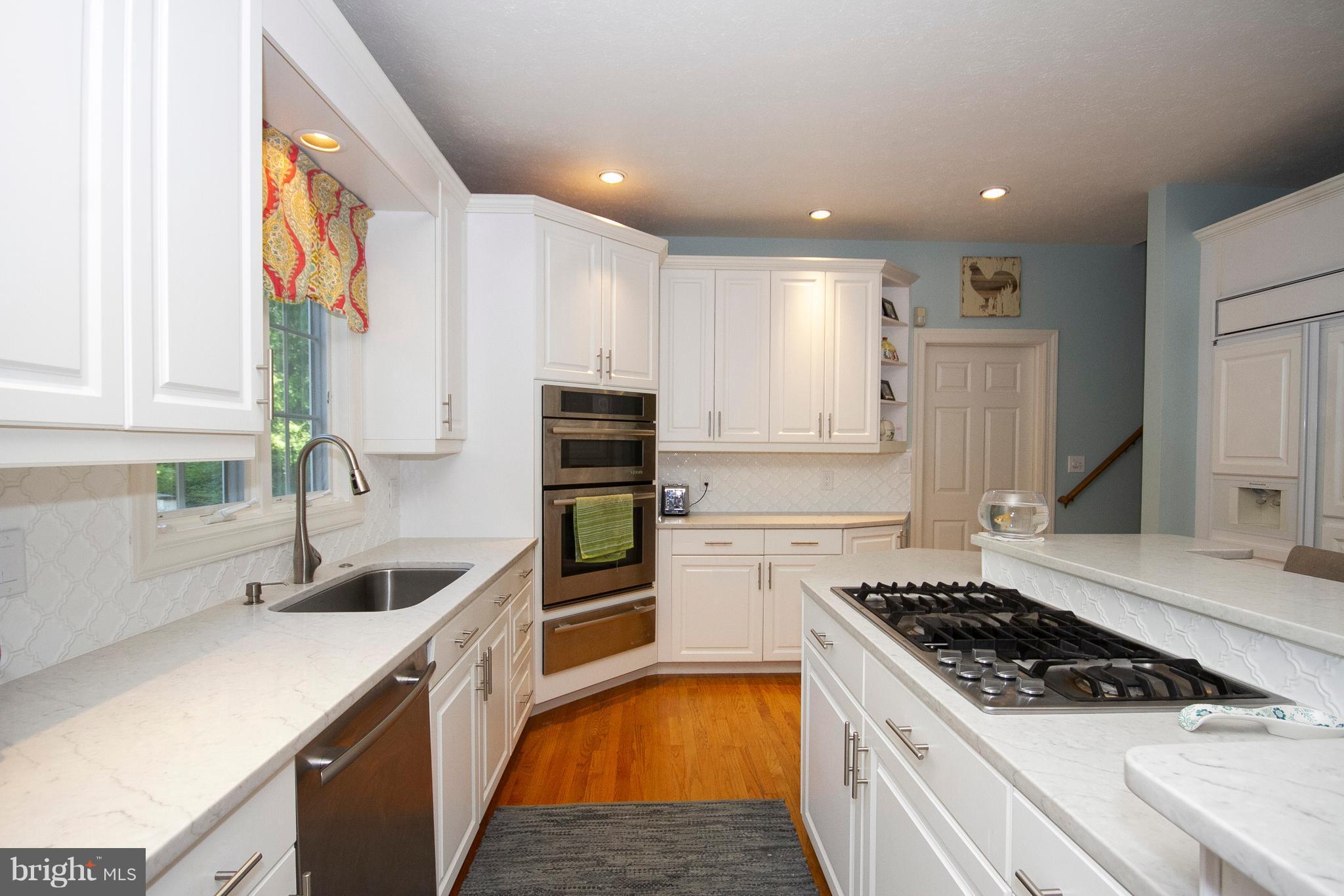 2818 Paper Mill Road Phoenix, MD 21131 - Photo 4 of 30 a kitchen with kitchen island granite countertop a sink stainless steel appliances and cabinets
