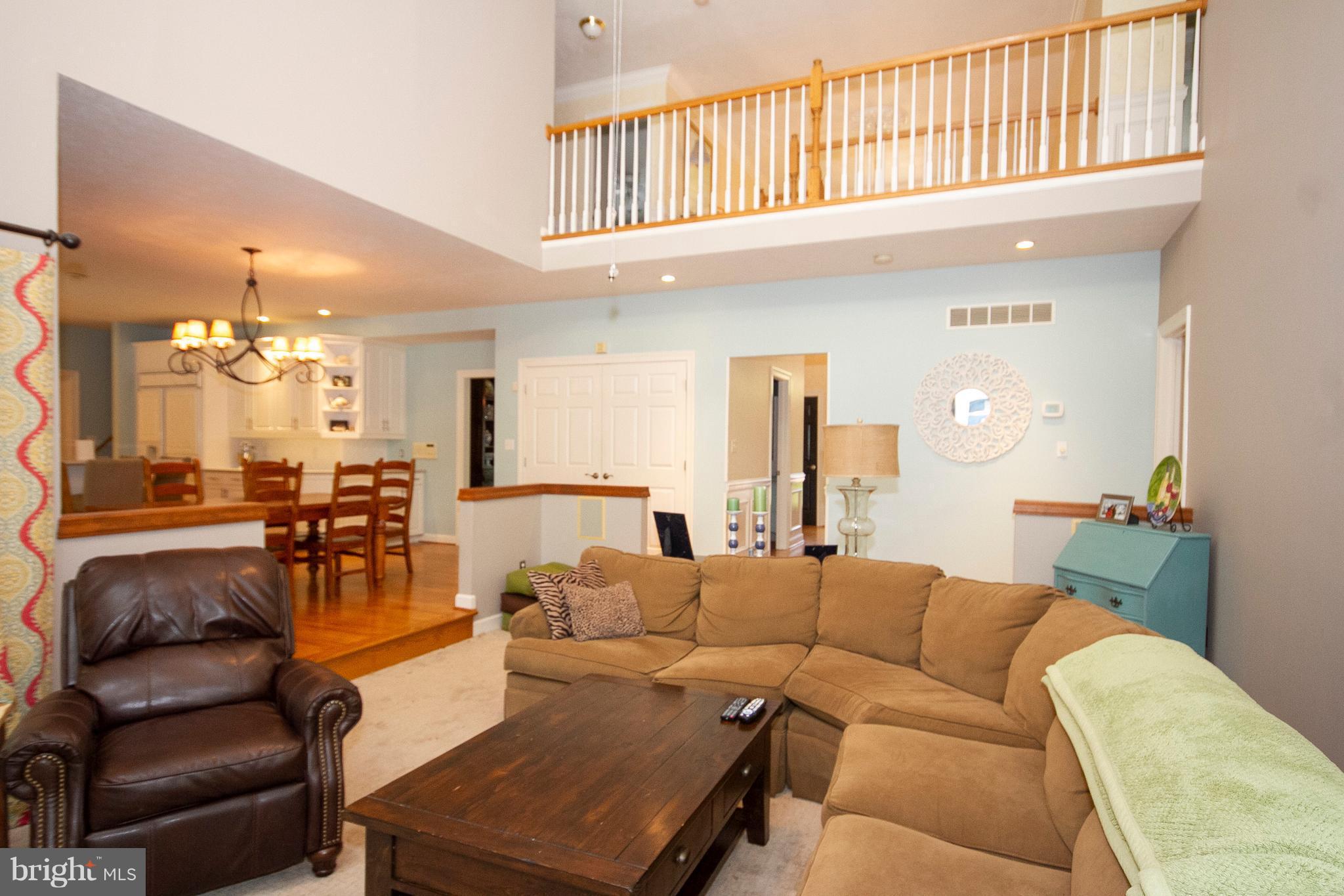 2818 Paper Mill Road Phoenix, MD 21131 - Photo 10 of 30 a living room with furniture a dining table and a chandelier