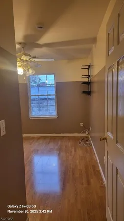 a view of a room with racks on the wall and a window