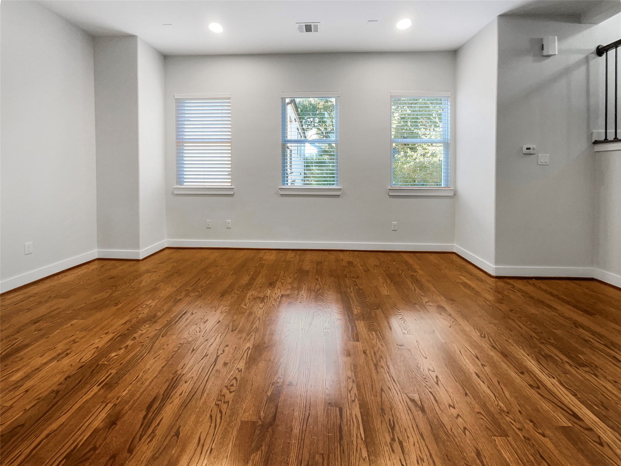 6625 Letein Street Houston, TX 77008 - Photo 3 of 17 an empty room with wooden floor and windows