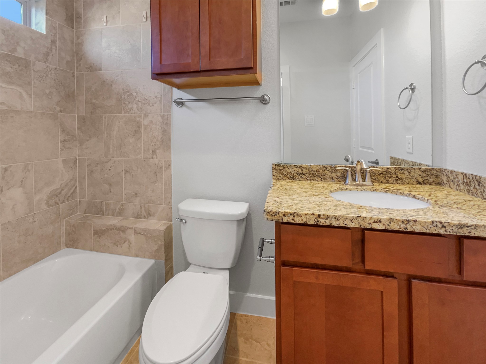 6625 Letein Street Houston, TX 77008 - Photo 9 of 17 a bathroom with a granite countertop toilet a sink and bathtub