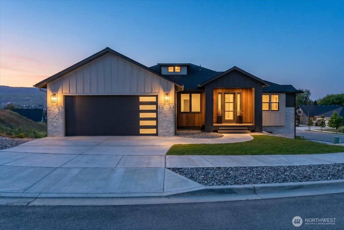 a front view of a house with a yard and garage