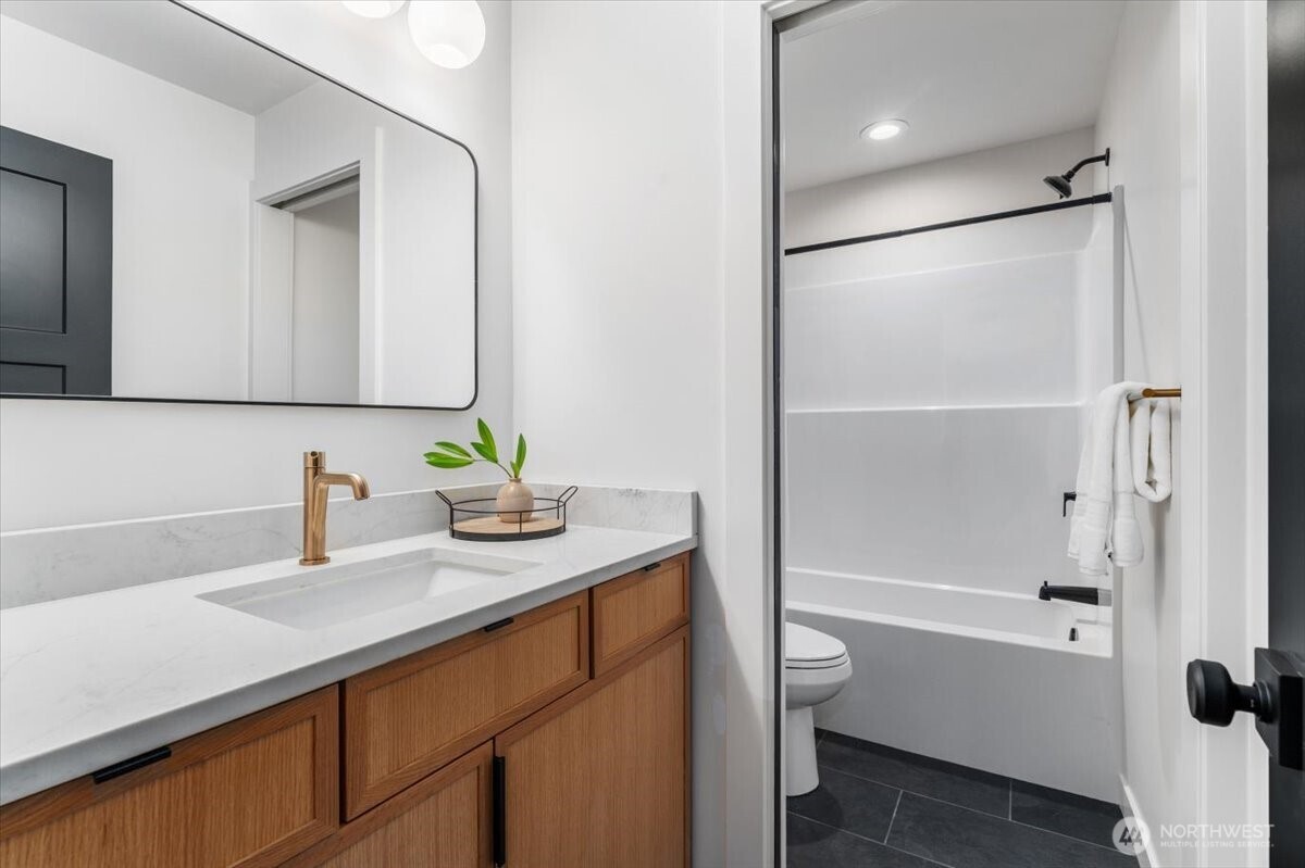 982 Spring Mountain Drive Wenatchee, WA 98801 - Photo 25 of 36 a bathroom with a granite countertop sink a toilet and shower
