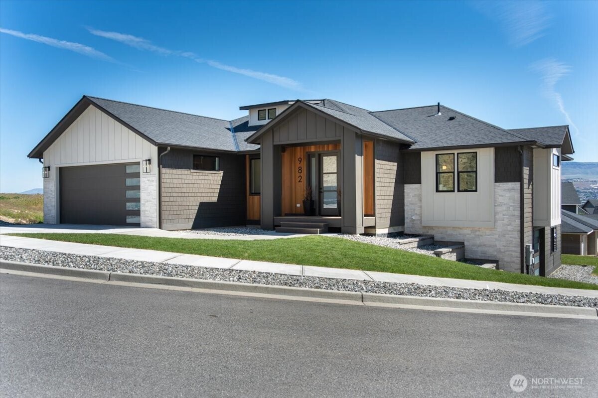982 Spring Mountain Drive Wenatchee, WA 98801 - Photo 33 of 36 a front view of a house with a yard and garage