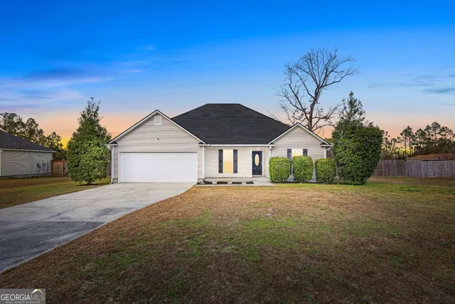 a front view of house with yard and trees