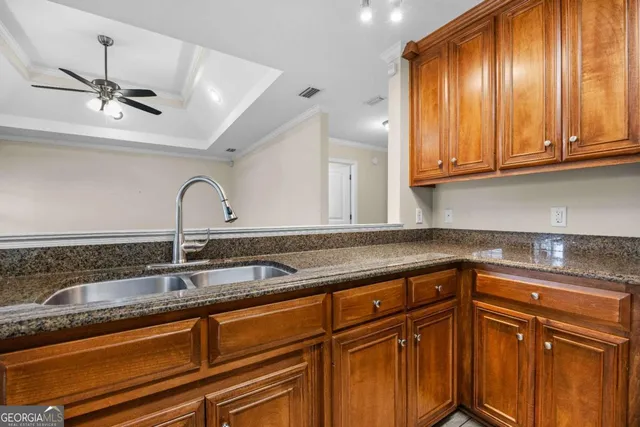 a kitchen with stainless steel appliances granite countertop a sink and cabinets