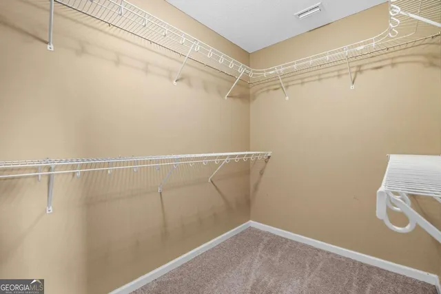 a bathroom with a granite countertop bathtub a sink and a large mirror