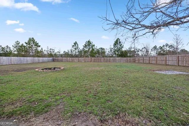 a view of an house with backyard space and a lake view