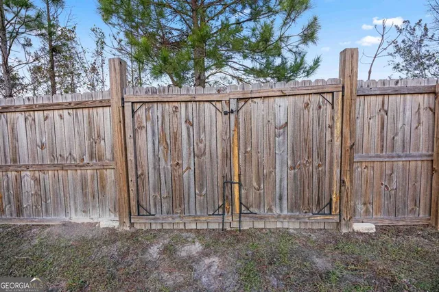 a front view of a house with a garden and yard