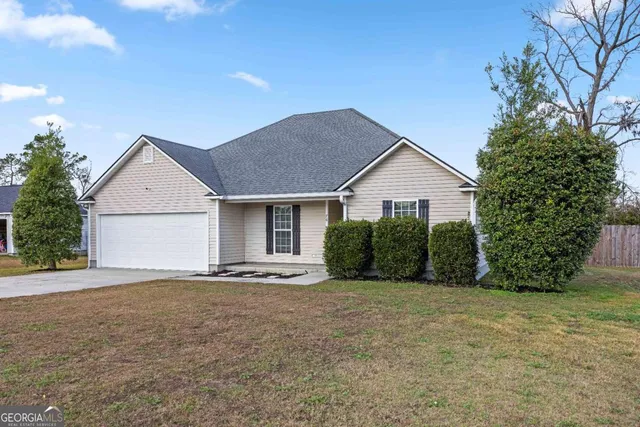a front view of house with yard and trees