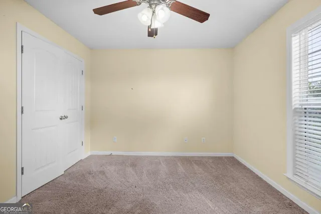a bathroom with a granite countertop bathtub shower sink vanity and toilet