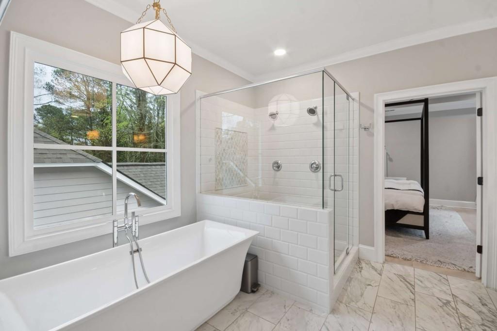 2561 Thompson Road Northeast Brookhaven, GA 30319 - Photo 20 of 47 a bathroom with a bathtub and a shower