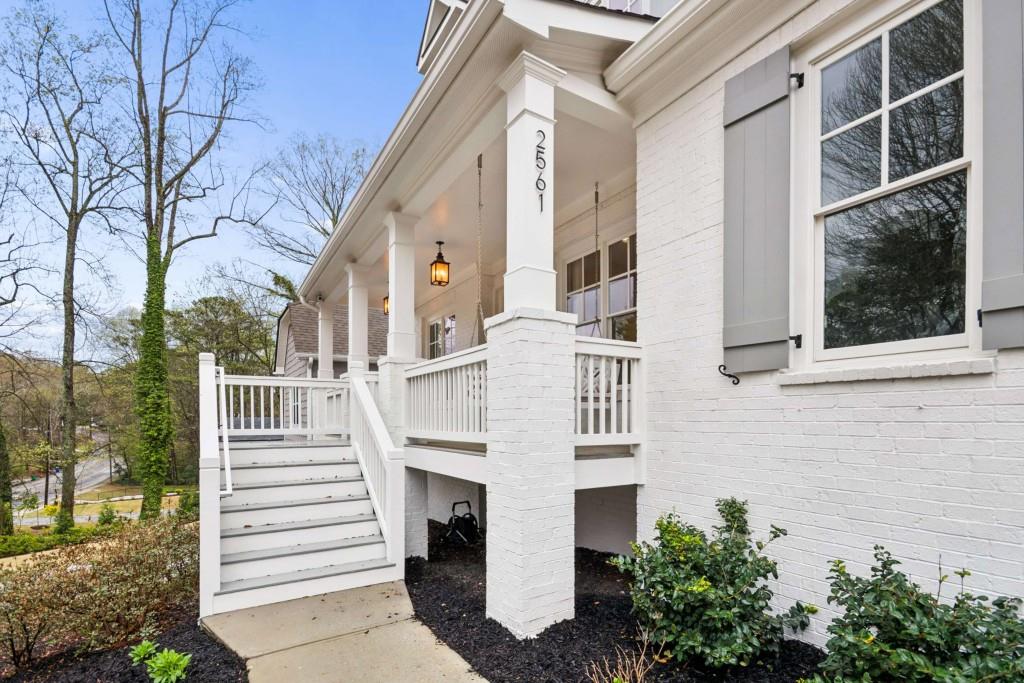 2561 Thompson Road Northeast Brookhaven, GA 30319 - Photo 2 of 47 a view of a white building with large windows and plants