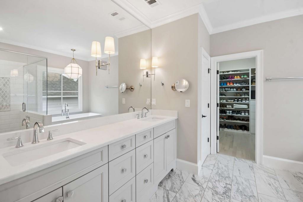 2561 Thompson Road Northeast Brookhaven, GA 30319 - Photo 21 of 47 a spacious bathroom with a shower double sink and a mirror