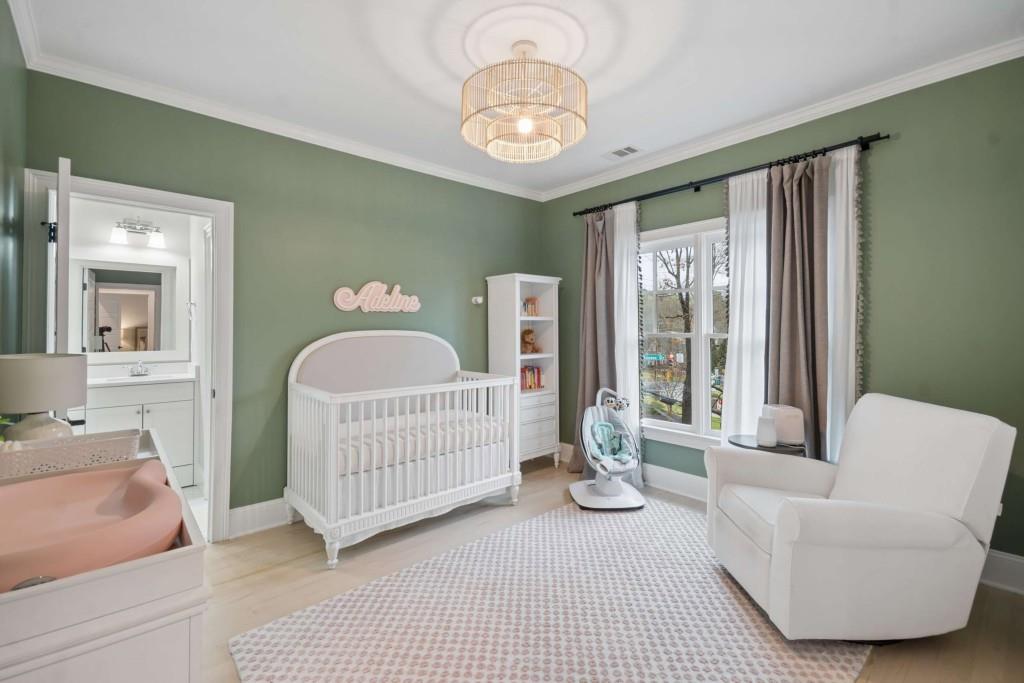 2561 Thompson Road Northeast Brookhaven, GA 30319 - Photo 25 of 47 a bedroom with a bed and a chandelier