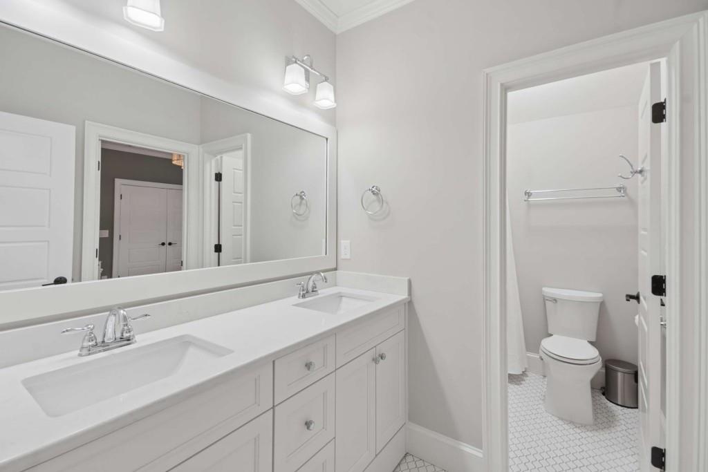 2561 Thompson Road Northeast Brookhaven, GA 30319 - Photo 26 of 47 a bathroom with a double vanity sink toilet and shower