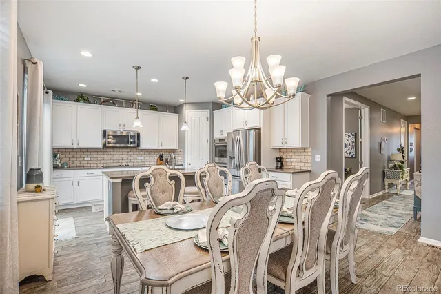 a large kitchen with a table and chairs