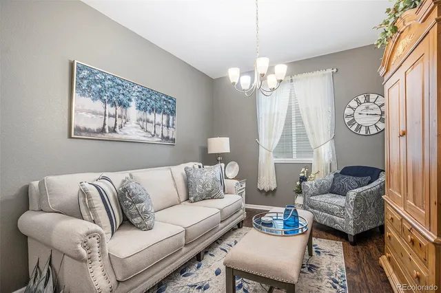 a living room with furniture a clock and a window