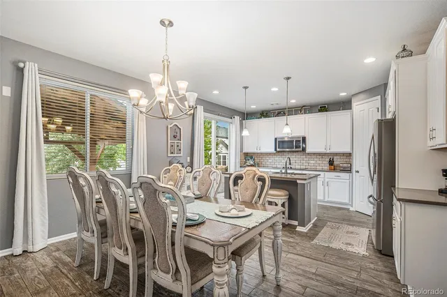 a view of a dining room with furniture large window and wooden floor