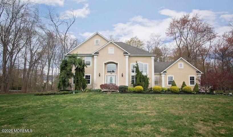 a front view of house with yard and green space