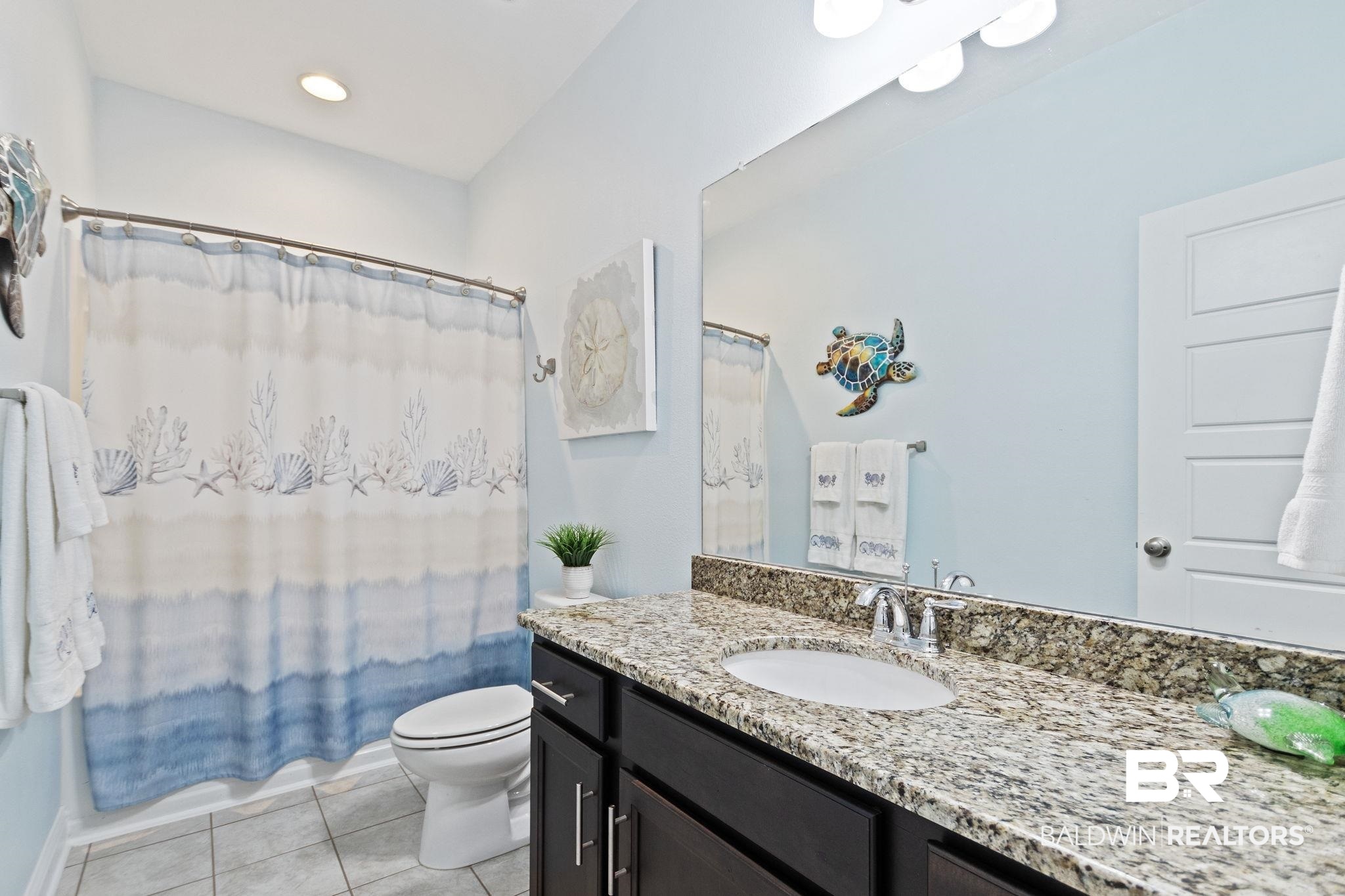 31541 Hoot Owl Road Daphne, AL 36527 - Photo 30 of 51 Bathroom with vanity, toilet, and tile patterned floors