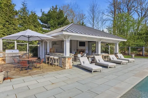 a view of a house with backyard porch and sitting area