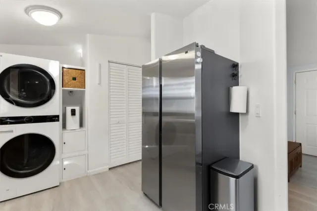 a kitchen with a refrigerator and washer