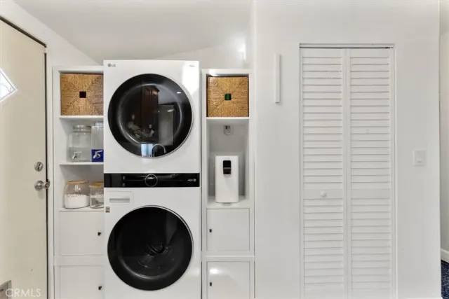a view of a hallway with washer and dryer