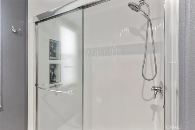 a bathroom with a glass shower door