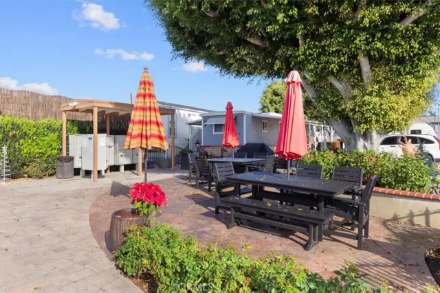 a front view of a house with fountain and potted plants