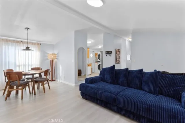 a living room with furniture a dining table and a piano table
