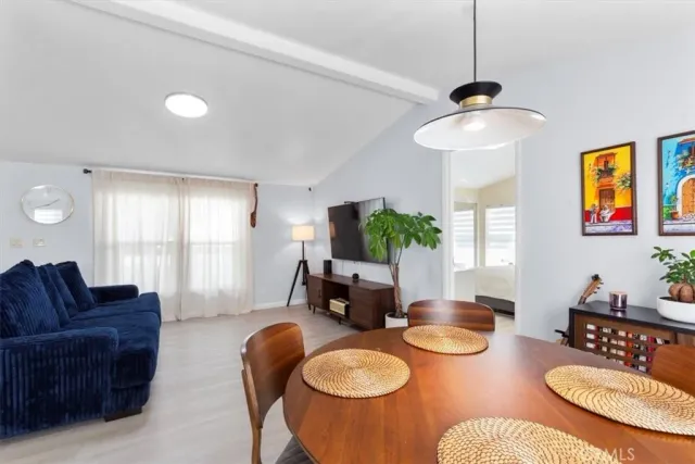 a living room with furniture a window and a chandelier
