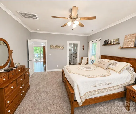 a bedroom with a bed and dresser with mirror