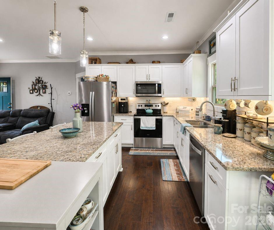 699 Sellerstown Road Cherryville, NC 28021 - Photo 8 of 22 a kitchen with kitchen island granite countertop a sink appliances cabinets and a counter top space