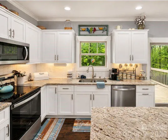 a kitchen with granite countertop a stove sink and cabinets