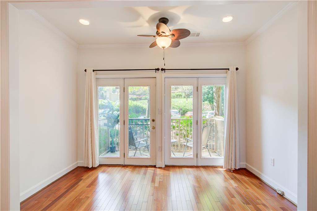 2865 Lenox Road Northeast, Unit 102 Atlanta, GA 30324 - Photo 15 of 35 a view of empty room with wooden floor and fan