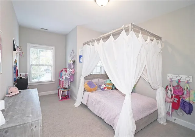 a bedroom with bed and a window