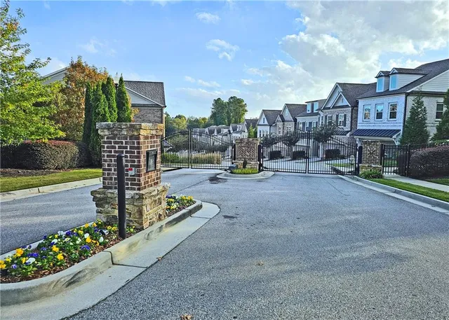 a city view with tall buildings and cars park side of road