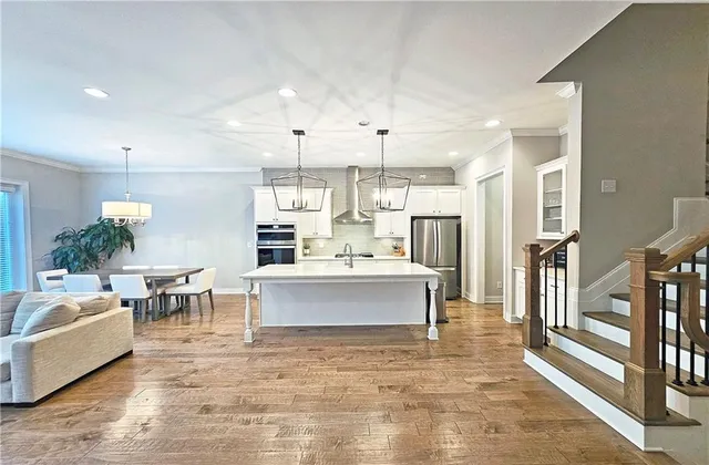 a large white kitchen with lots of counter space and appliances