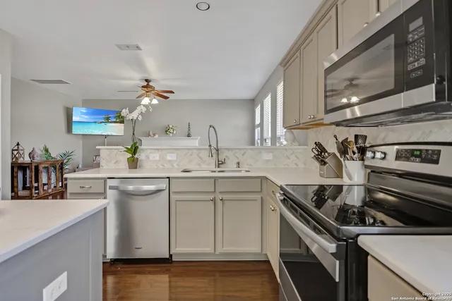 a kitchen with a sink stove and cabinets
