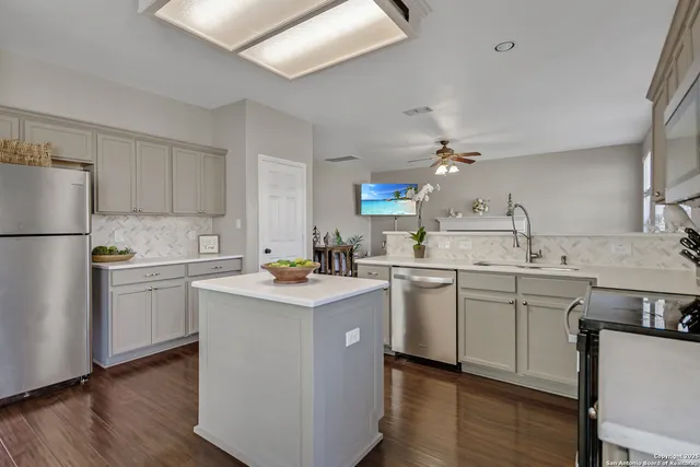 a kitchen with white cabinets and white appliances