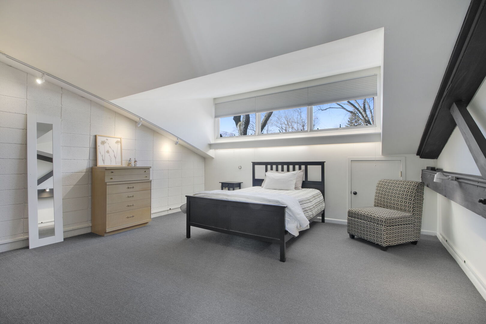 241 East Burlington Street, Unit C Riverside, IL 60546 - Photo 16 of 27 a spacious bedroom with a bed and a couch
