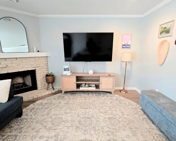 a living room with furniture window and a flat screen tv
