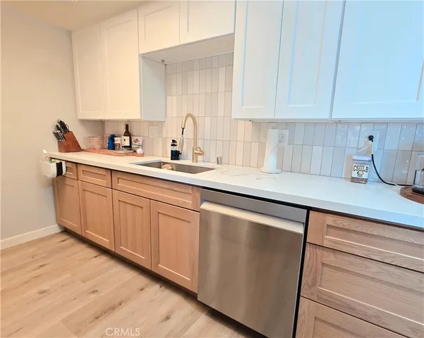 a kitchen with stainless steel appliances a stove microwave and sink