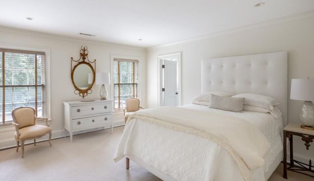 a bedroom with a bed a couch and dresser